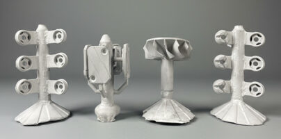Examples of investment casting geometry on a gray background.